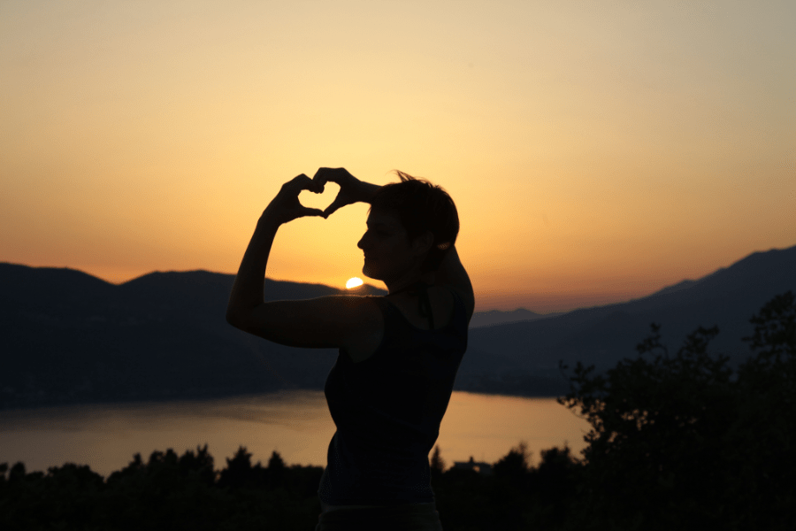 heart sign silhouette on a sunset background